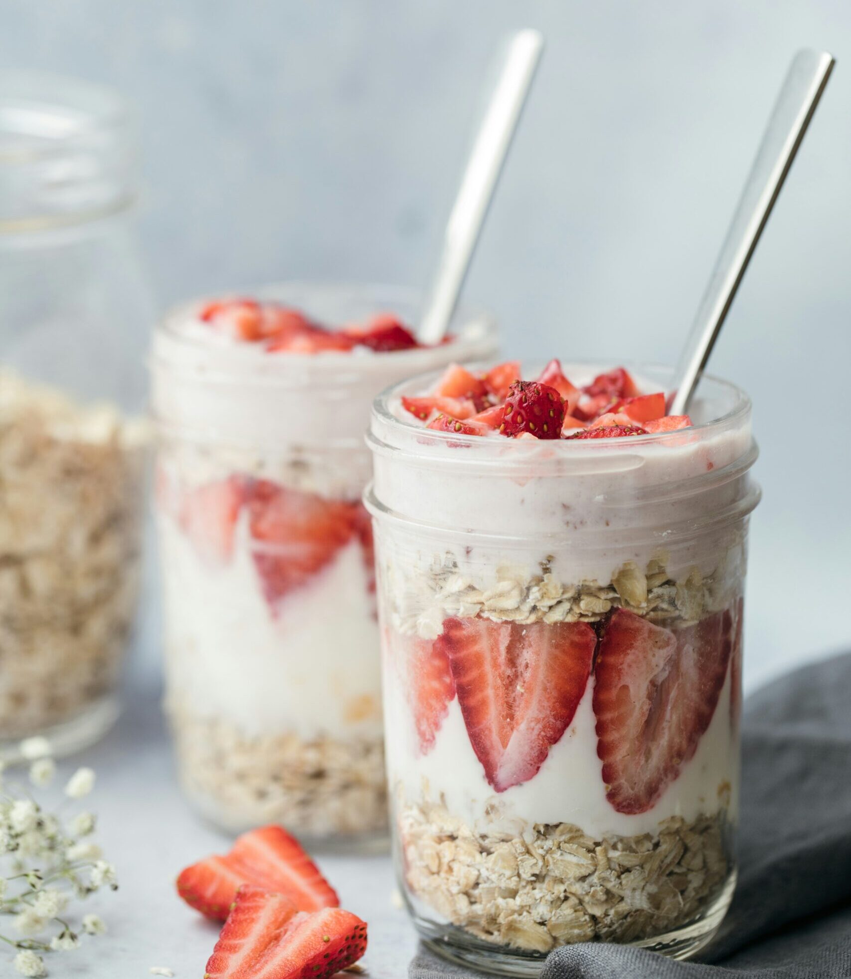 Delicious strawberry yogurt parfaits in mason jars, layered with creamy yogurt, fresh strawberries, and granola, perfect for a healthy breakfast or snack.